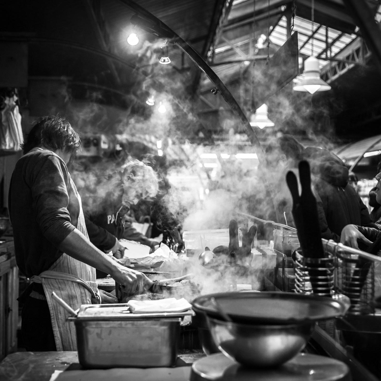Diverse group of community members sharing a meal together, showcasing the social bonds formed through collaborative cooking